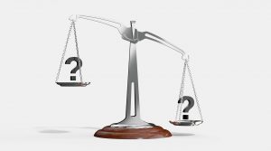 a silver scale with two question marks on each side of the scale with one side lower than the other.