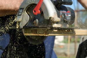 table saw cutting a piece of wood.