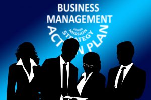 silhouettes of 4 people in business suits with business management as the headline