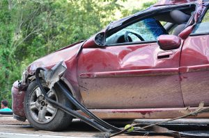 maroon car with damage done to the front and side