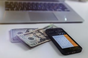 money with a calculator next to it