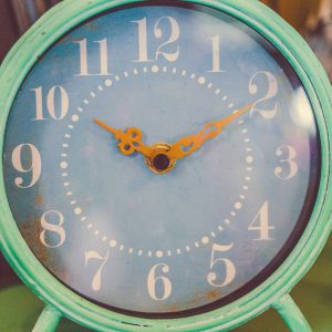 teal clock with the little hand on 10 and the big hand on 2