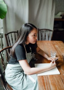 young woman sitting at a dinner table looking straight