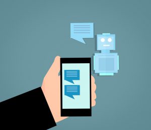 illustration of a hand holding a cell phone with a chat on the screen and a robot next to the phone with a chat box