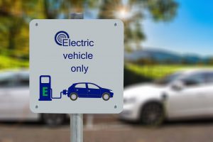 electric vehicle parking only sign with a car on it and an e-charging station.