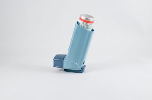 a light blue colored inhaler