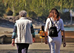 older womana nd a younger woman walking together