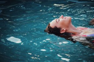 caucasian woman floating in water