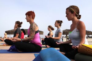 group of women doing yoga outside