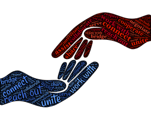 one hand reaching for another with words of unite and connecting in the hands