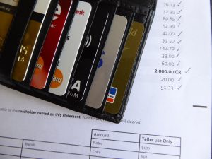 credit cards in a wallet next to a statement