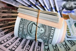 stack of money rolled up with a rubber band on it