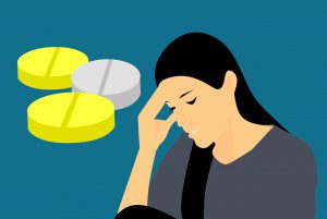 illustration of a women holding the side of her head with pills next to her