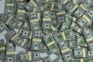 stacks of hundred dollar bills in stacks laying on top of each other