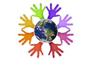 planet earth with different colored hands coming out from all around it