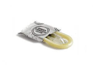 condom halfway out of a silver wrapper.