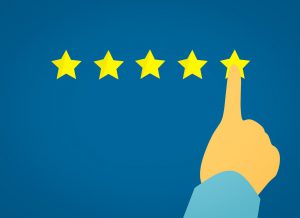 a finger pointing at the 5th star of a rating