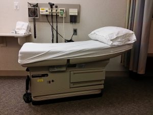 exam room with bed and medical equipment