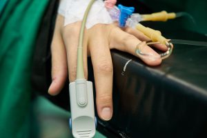 person's hand with wires all around it