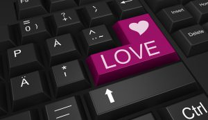 a black keyboard with a purple key with the word love on it and a heart