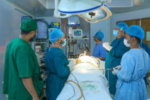 operating room with someone on the table and doctors surrounding