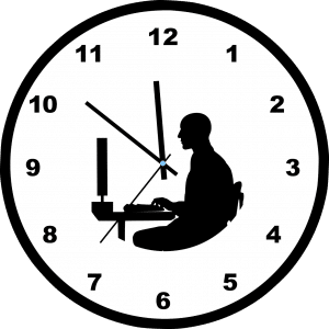 clock with silhouette of a person sitting at a desk in front of a computer inside of it