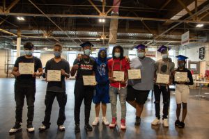 kids standing next to each other holding a certificate