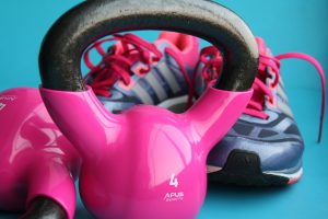 pink kettle bells with sneakers in the background
