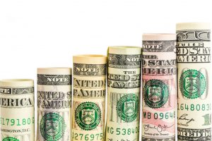 money bills rolled up lined up going upwards
