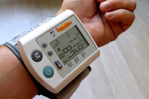 blood pressure cuff on someone's wrist