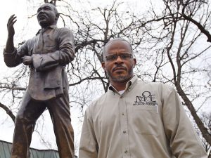 Richard Miles standing in front of a statue.