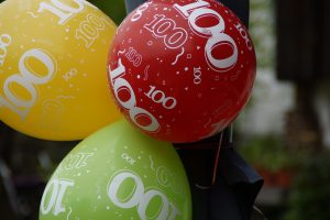 different colored balloons with 100 on them