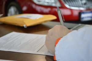 hand filling out paperwork