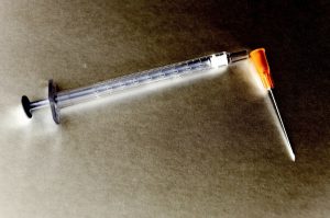 a medical needle with the top off