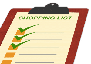 clipboard with a shopping list header and checkmarks on 3 boxes