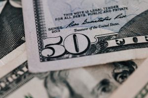 $20 dollar bill underneath a $50 bill