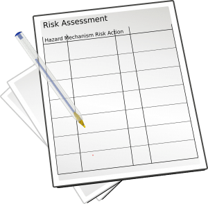 paper with the words risk assessment on the top and a pen on the paper
