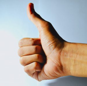 mans hand with a thumb up