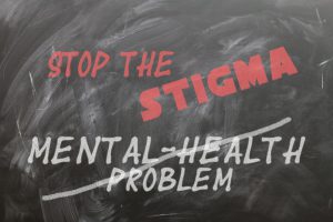 chalkboard with stop the stigma written on it in red