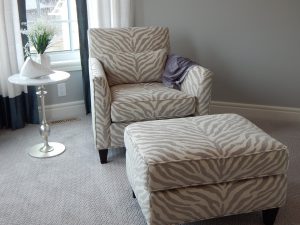 a chair and ottoman that is tan and white zebra print