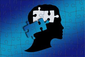 puzzle of a person's head with two pieces missing.