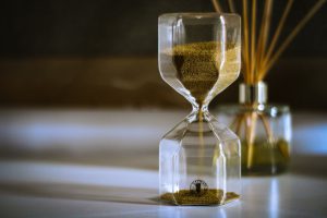 hourglass filled with sand on the top sprinkling down