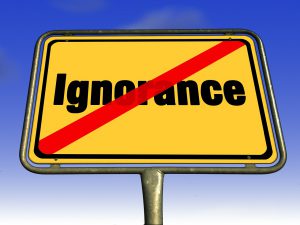 ignorance written on a sign with a red line through it