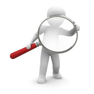 illustration of a person holding a large magnifying glass looking through
