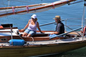 two older people sitting on a boat in the sun