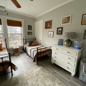 room with 2 beds in it and a dresser 