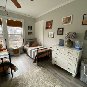 room with 2 beds in it and a dresser