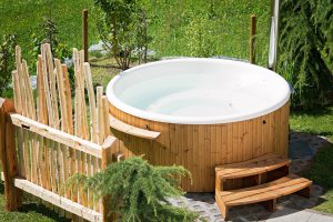 white hot tub with wood panels around it