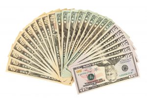 different numerations of money bills laid out like a fan
