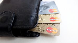 credit cards sticking out of a black wallet